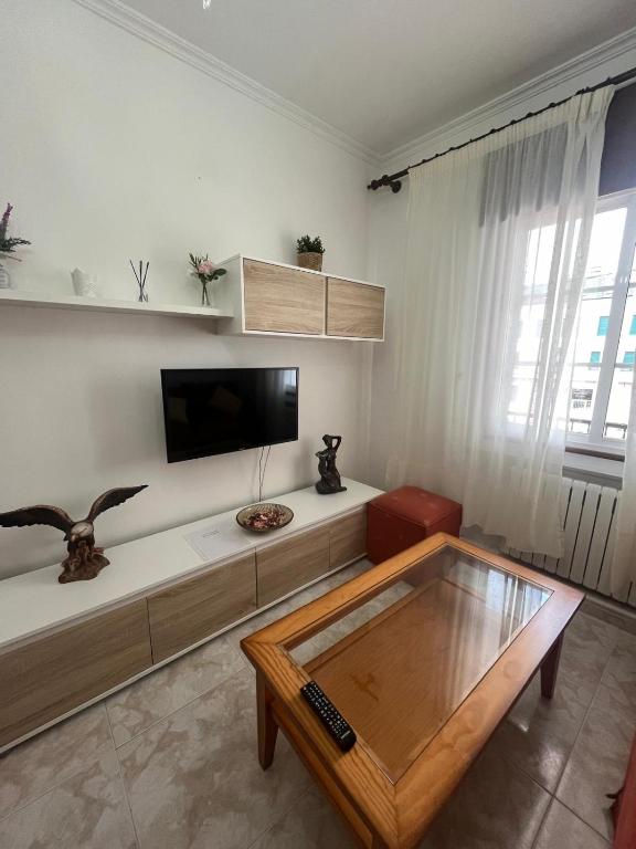 a living room with a tv and a coffee table at Rúa da Igrexa Miño in Miño