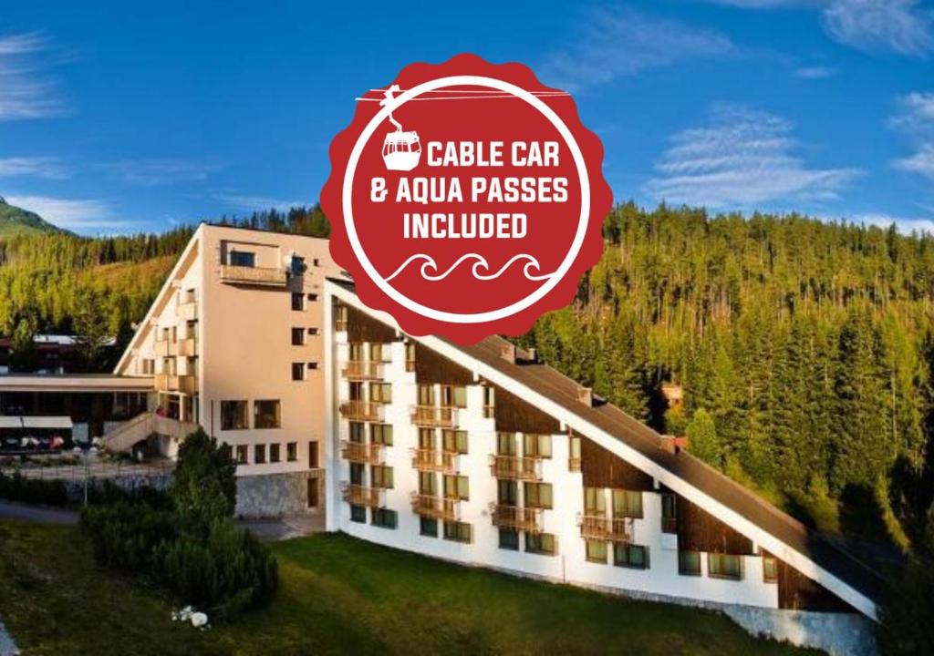 a hotel with a sign that reads castle cafe andanu passes included at Hotel FIS in Štrbské Pleso