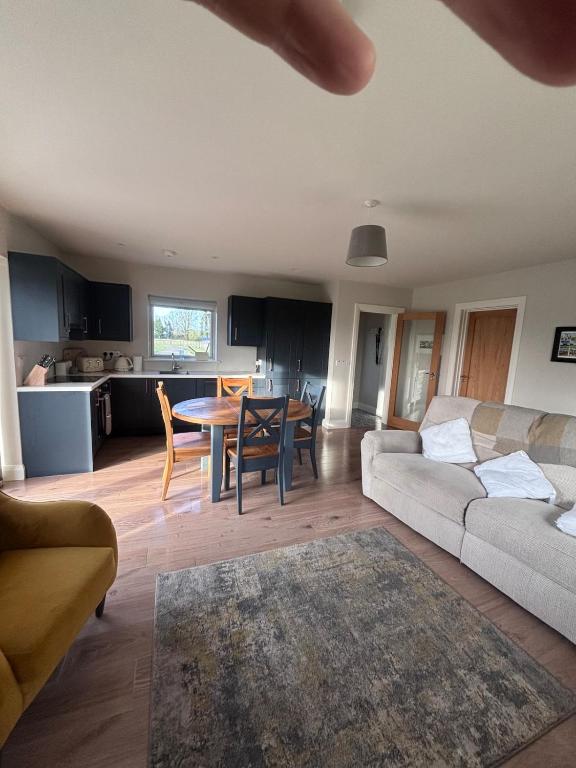a living room with a couch and a table at Moate View Lodge in Ballymore Eustace