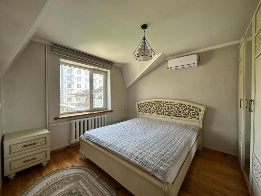 a bedroom with a bed and a window at Stay Osh in Osh