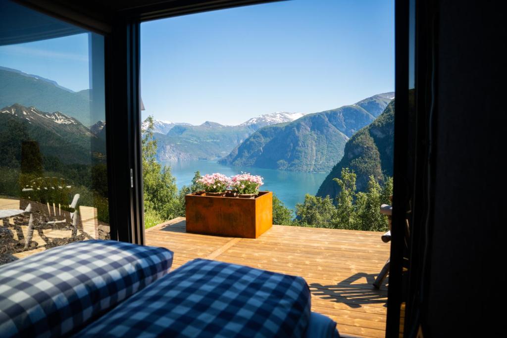 a room with a view of a lake and mountains at Kilsti Lodge in Eidsdal