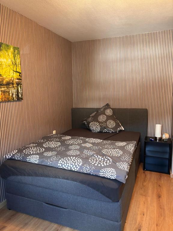 a bedroom with a bed and a striped wall at Päächenhof in Sinspelt