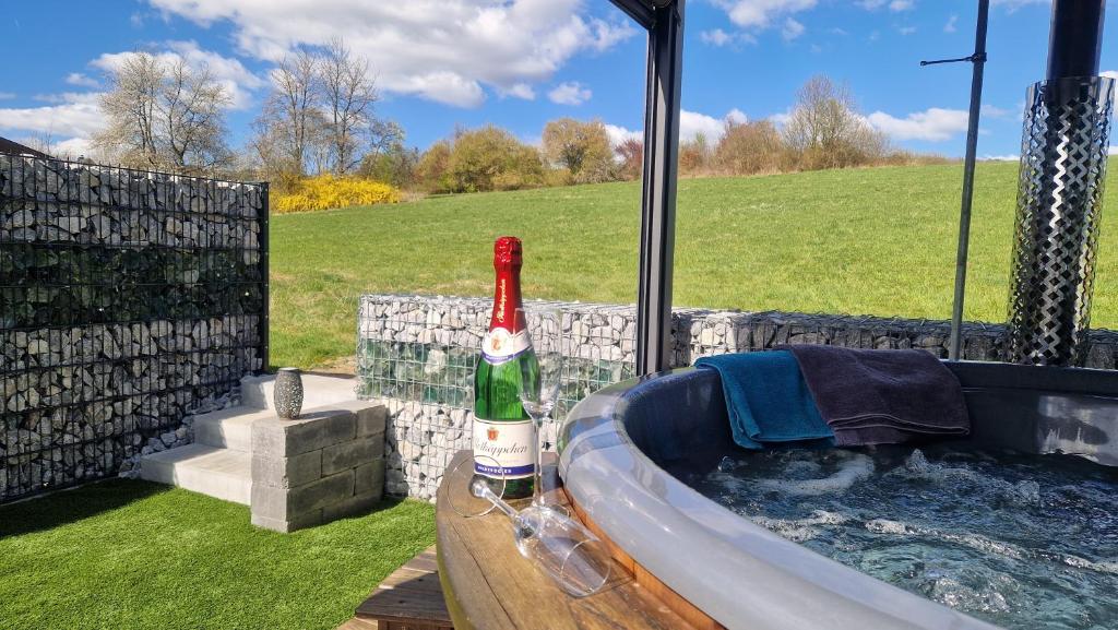 a bottle of champagne sitting in a bath tub at "Fewo am Siegsteig" in Dattenfeld