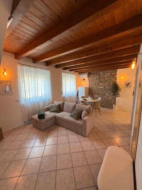 a living room with a couch and a table at Garda Green - Luxury Apartment in Lonato