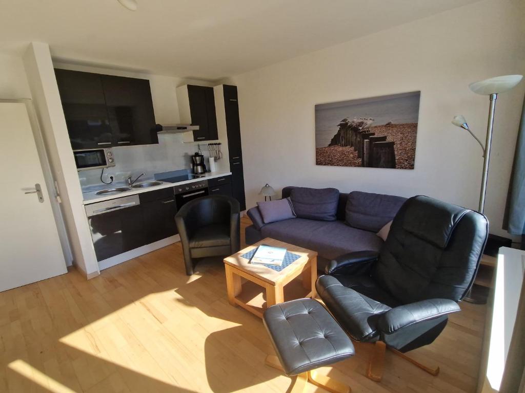 a living room with a couch and a table at Nordseeperle in Hooksiel