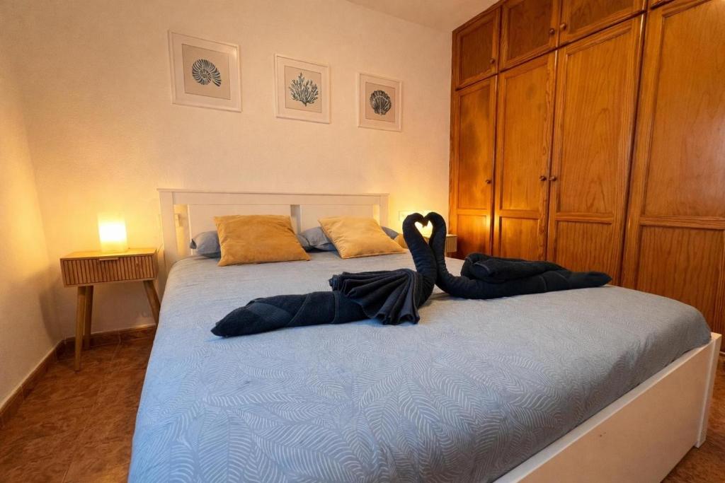 a bedroom with a bed with two people laying on it at Kalendra Jable in Guatiza