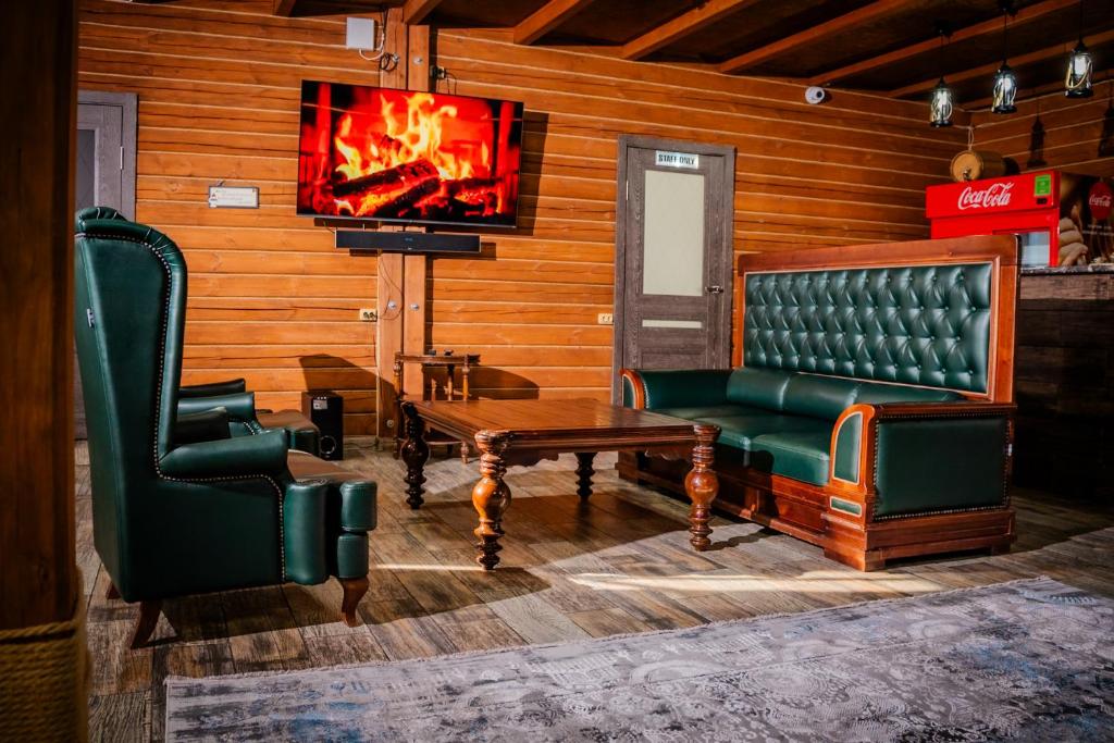 a living room with a couch and a tv at KokTau in Kokshetau