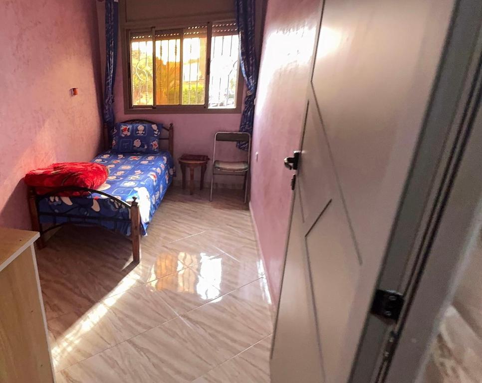 a small room with a bed and a door at Imi Ouaddar Sea View Retreat in Agadir
