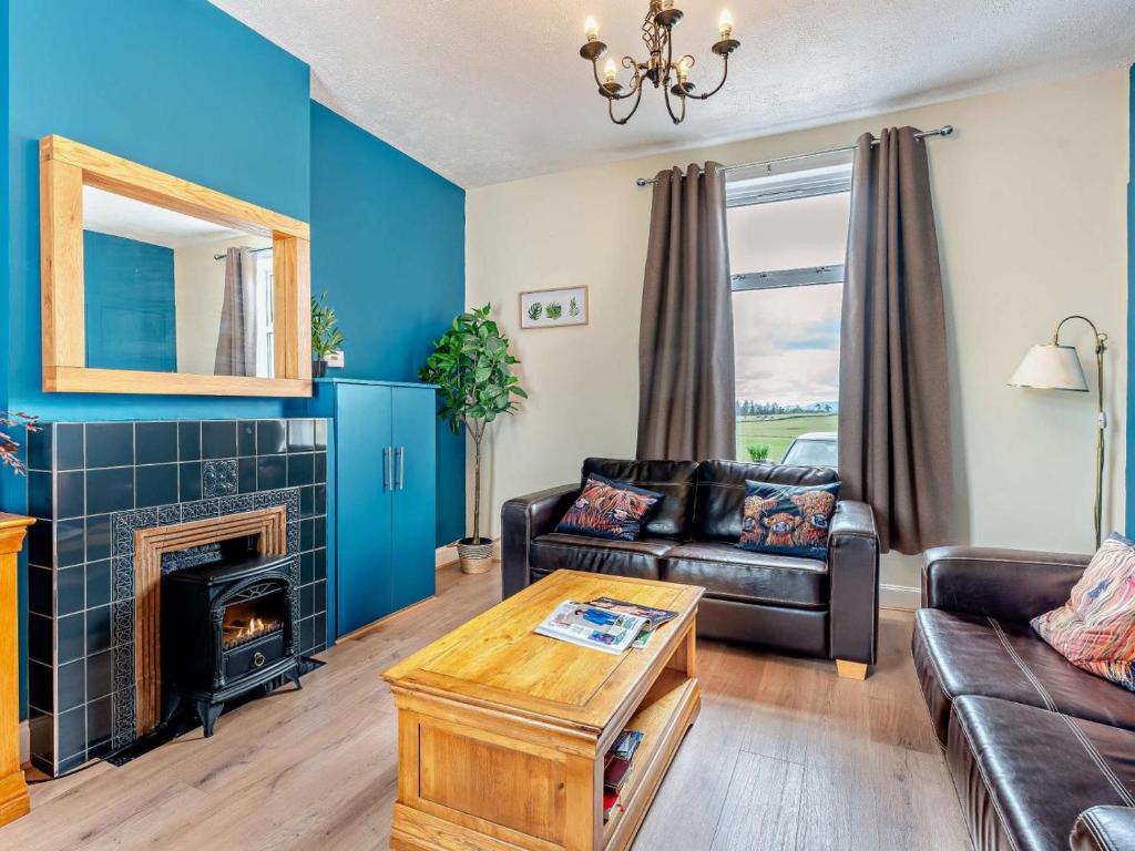 a living room with a couch and a fireplace at 2 Bed in Carluke oc-95359 in Carluke
