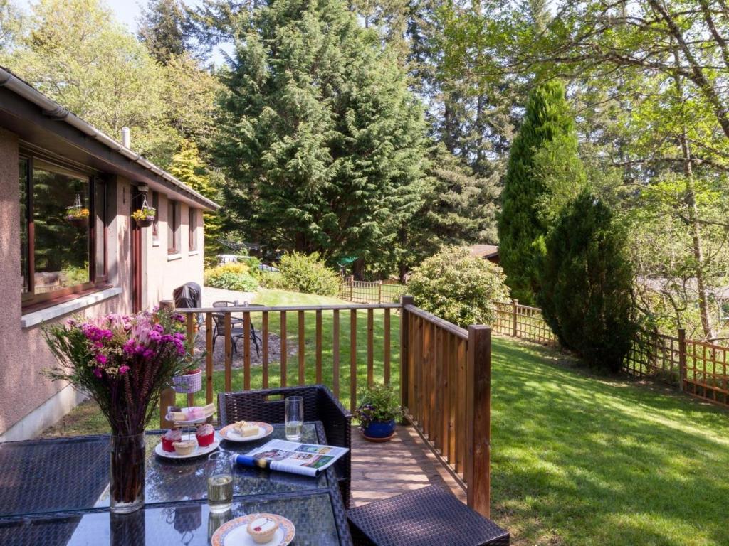 a patio with a table and chairs on a fence at 3 Bed in Inverness oc-in633 in Balnain