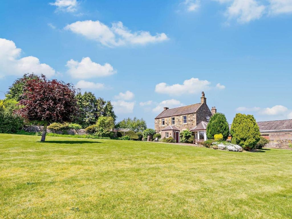 a large grassy field in front of a house at 3 Bed in Lochgelly oc-ff224 in Kinglassie