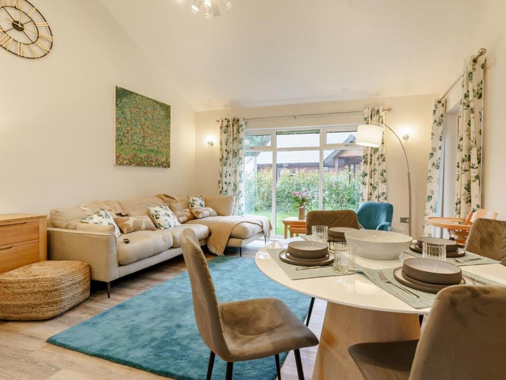 a living room with a table and a couch at 2 Bed in Swansea oc-91725 in Killay