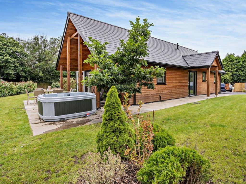 a house with a hot tub in the yard at 3 Bed in Swansea oc-91722 in Killay