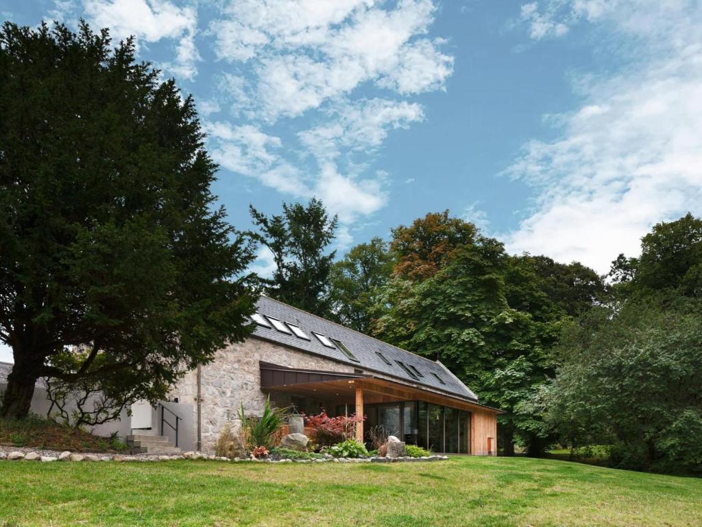 a stone building in a field with trees at 4 Bed in Aberdeen oc-93914 in Dyce