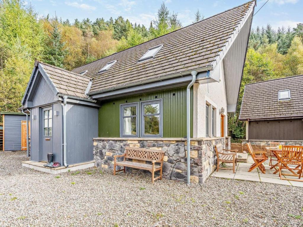 a house with a bench in front of it at 3 Bed in Callander oc-79359 in Callander