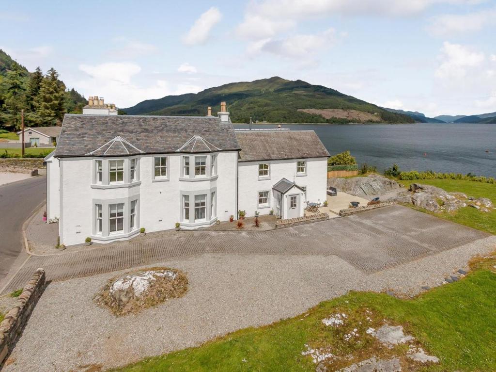 an aerial view of a house with a large driveway at 4 Bed in Dunoon oc-79529 in Ardentinny