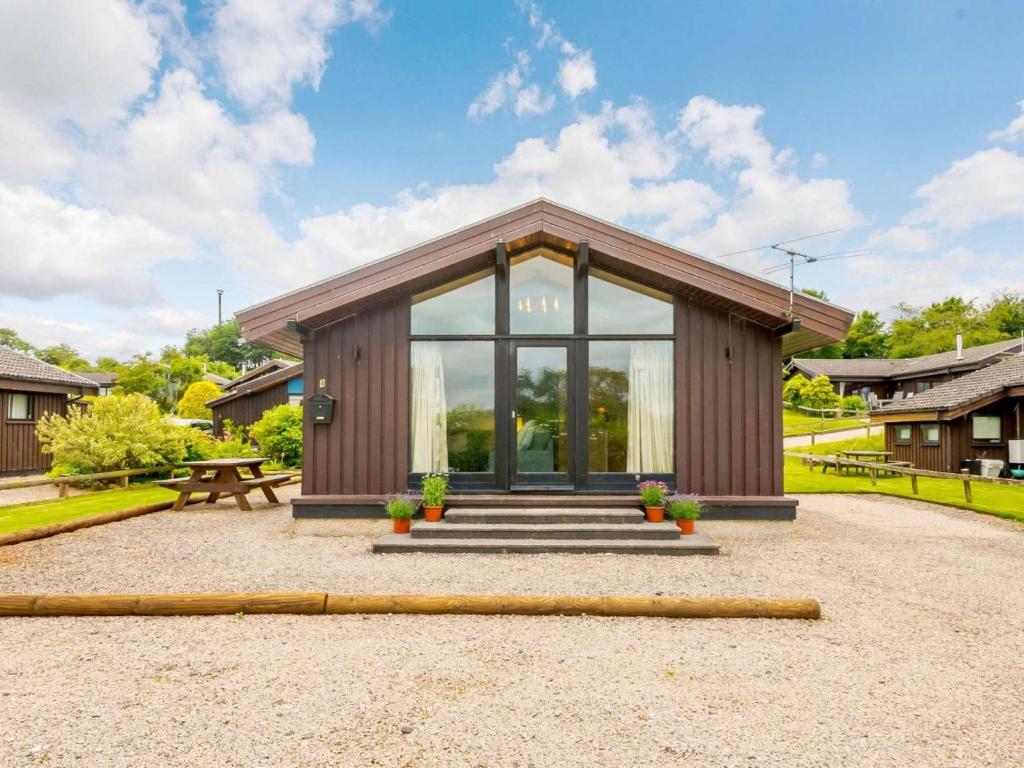 a small building with glass doors and a picnic table at 3 Bed in Penrith oc-88212 in Tirril