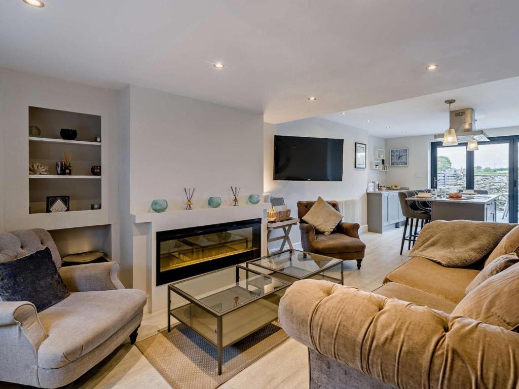 a living room with two couches and a fireplace at 2 Bed in Grange-over-sands oc-73154 in Cartmel