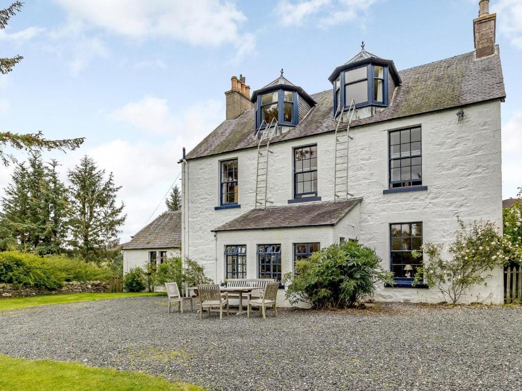 a large white house with a table and chairs at 5 Bed in Blairgowrie oc-ca409 in Cray