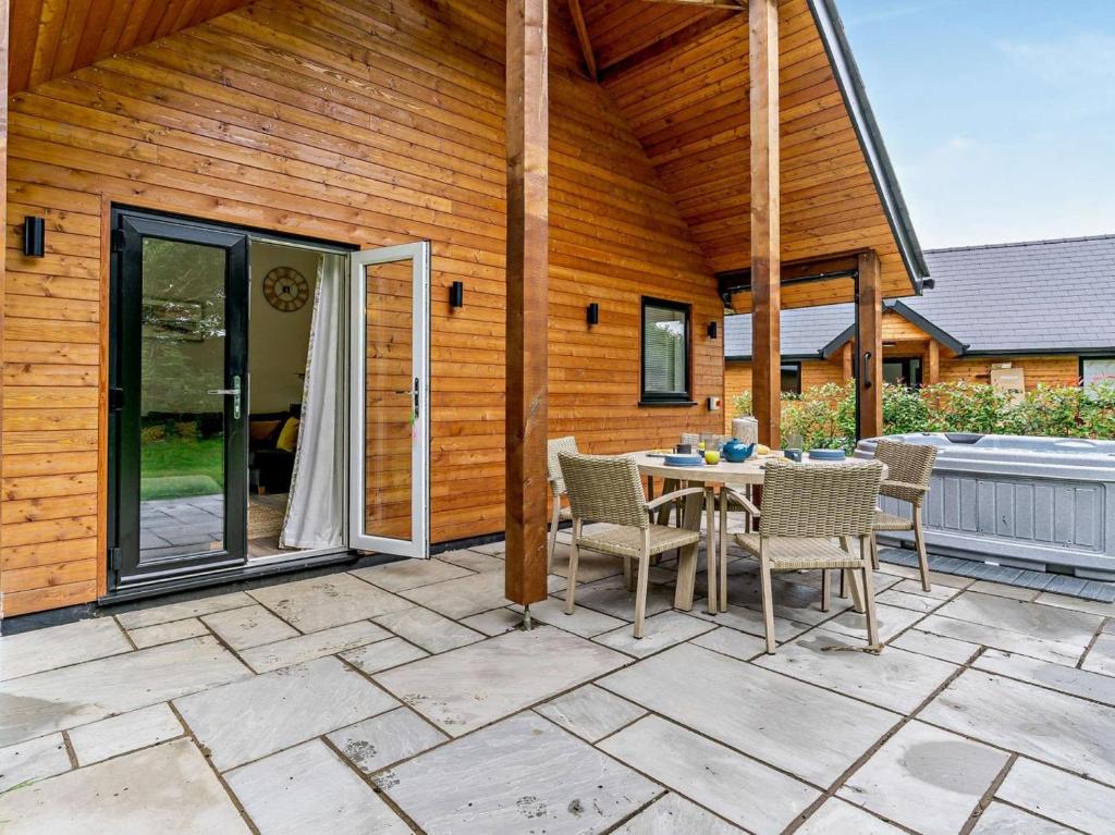 a patio with a table and chairs on it at 3 Bed in Swansea oc-91729 in Killay