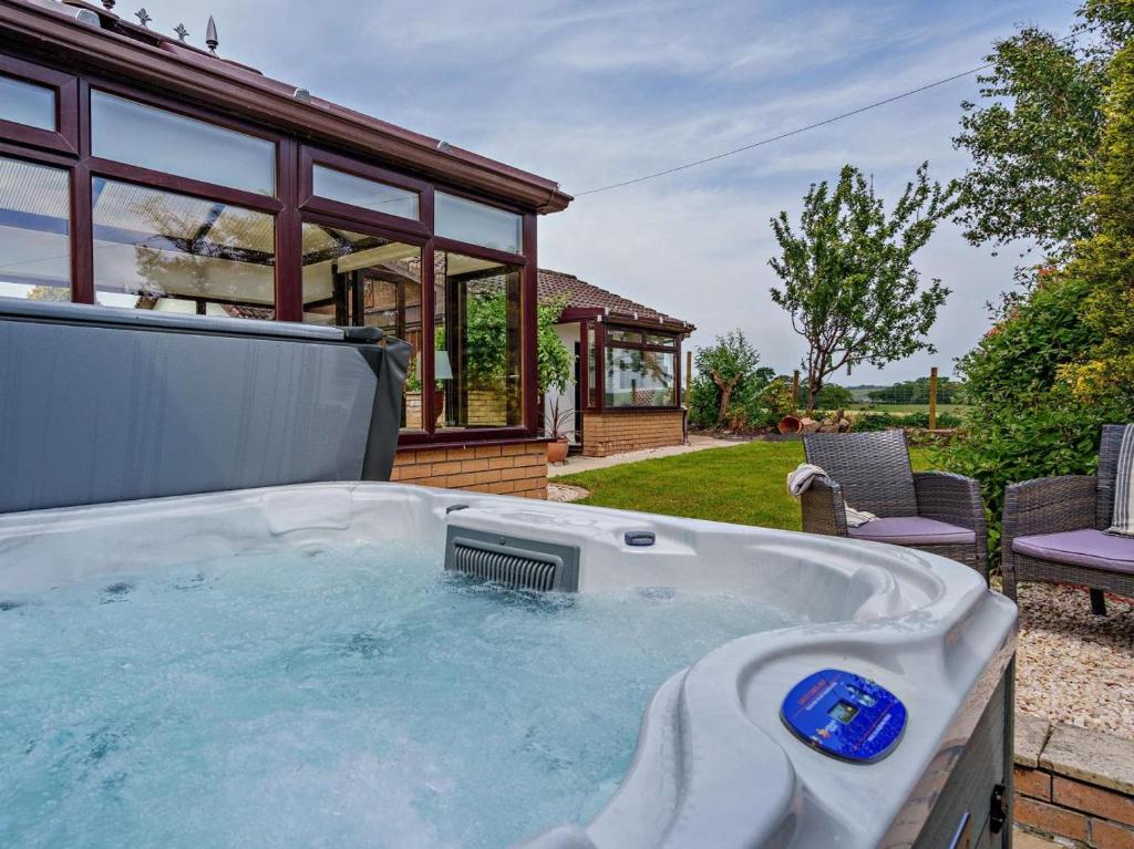 a hot tub in front of a house at 3 Bed in Falkirk oc-96124 in Avonbridge