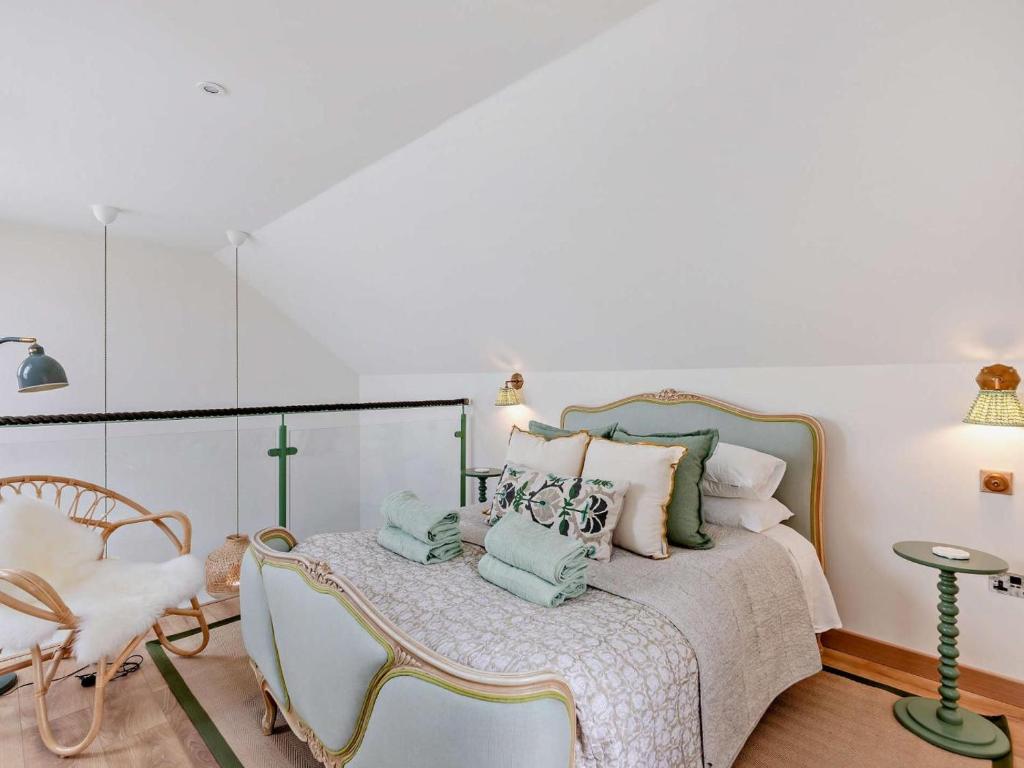 a white bedroom with a bed and a chair at 1 Bed in Gateshead oc-95877 in Lamesley