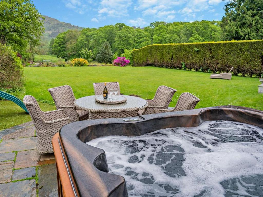 a patio with a table and chairs in a yard at 2 Bed in Ulverston oc-94926 in Lakeside