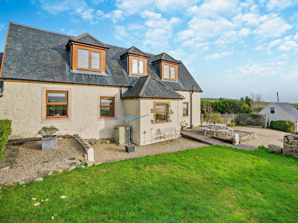an exterior view of a house with a yard at 3 Bed in Isle Of Arran oc-ca099 in Sliddery