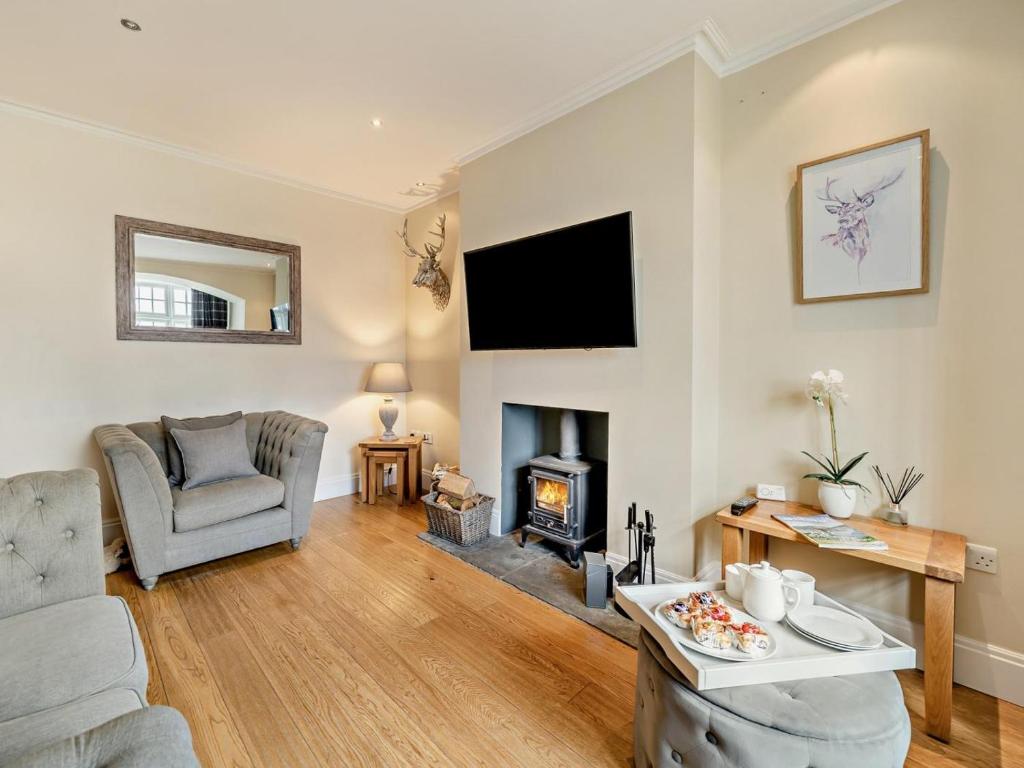 a living room with a couch and a fireplace at 2 Bed in Grange-over-sands oc-83546 in Cartmel