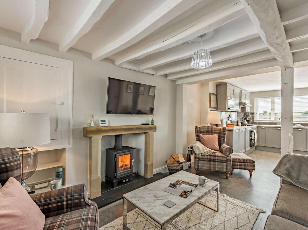 a living room with a fireplace and a couch at 2 Bed in Grange-over-sands oc-89206 in Cartmel