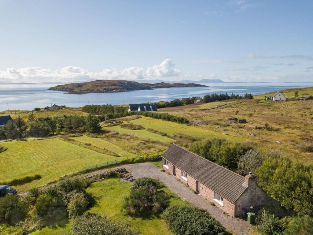 an aerial view of a house on a hill next to the ocean at 2 Bed in Gairloch oc-ca137 in Big Sand