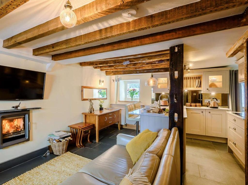 a living room with a couch and a fireplace at 1 Bed in Grange-over-sands oc-89364 in Cartmel