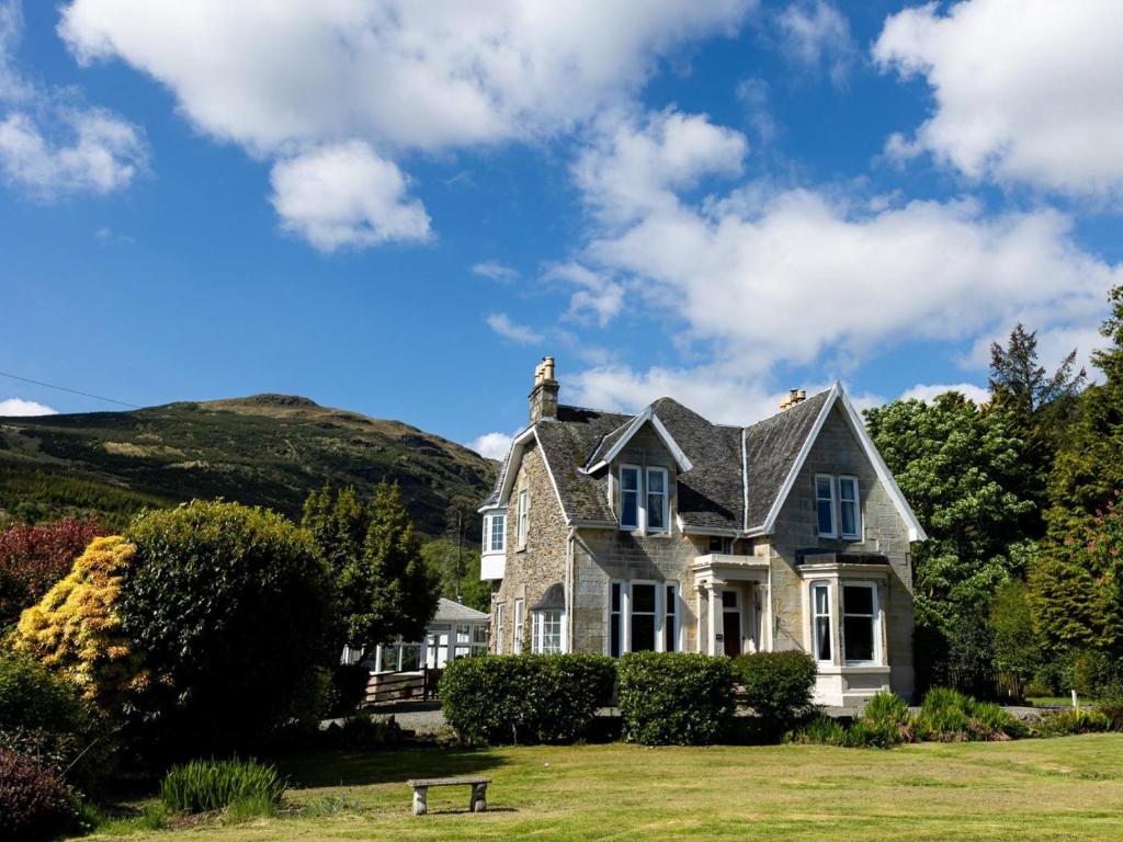 a house with a hill in the background at 5 Bed in Lochgoilhead oc-ca279 in Carrick