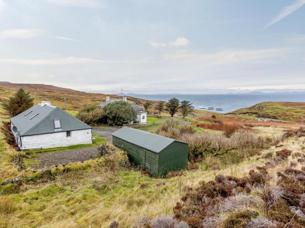 an aerial view of a house and a barn in a field at 1 Bed in Isle Of Skye oc-ca073 in Glendale