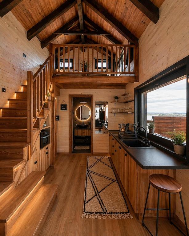 a kitchen with a counter and a sink in a cabin at BeLaWood in Egerszalók