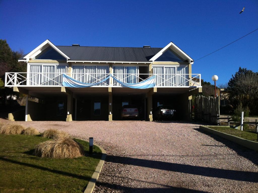 a house with a large driveway in front of it at Altos de Ventana in Sierra de la Ventana