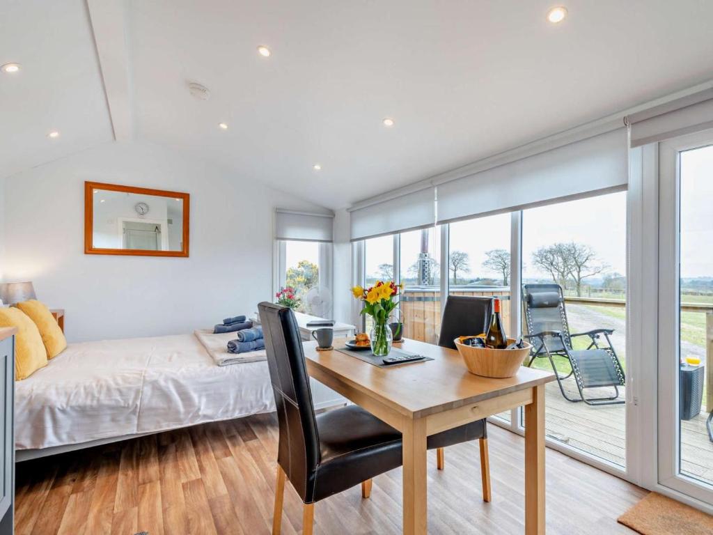a bedroom with a bed and a table with flowers on it at 1 Bed in Dalry oc-91418 in Dalry