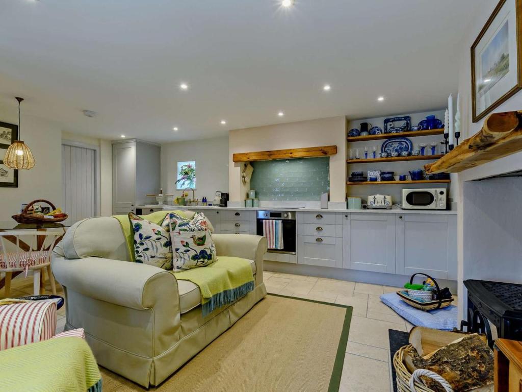 a living room with a couch and a kitchen at 1 Bed in Hawick oc-91437 in Denholm
