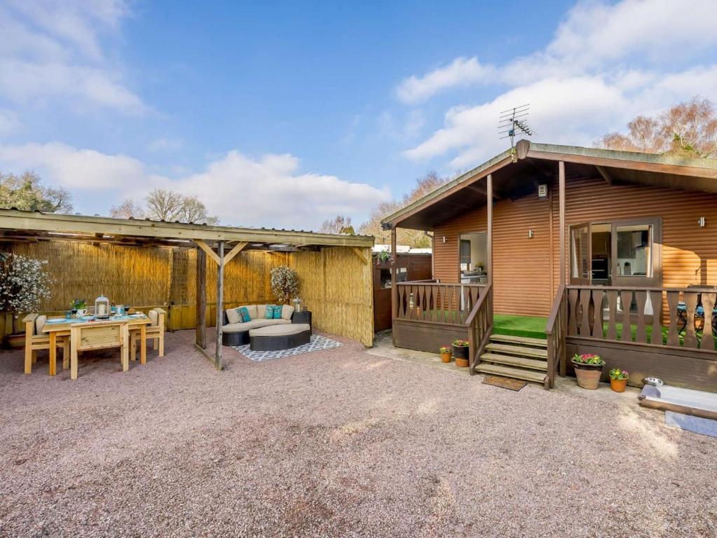 a home with a patio and a house with a table at 1 Bed in Northwich oc-91266 in Whitegate