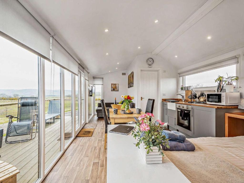 a kitchen and living room with views of the ocean at 1 Bed in Dalry oc-91417 in Dalry