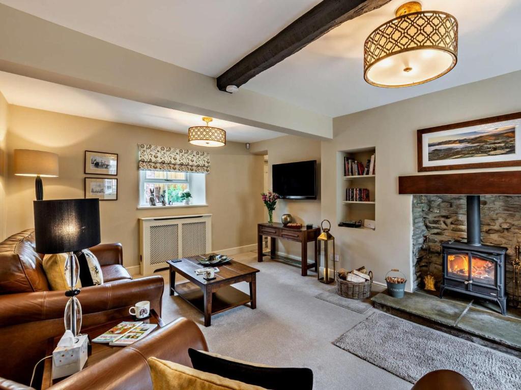 a living room with a couch and a fireplace at 3 Bed in Middleham oc-78935 in Middleham