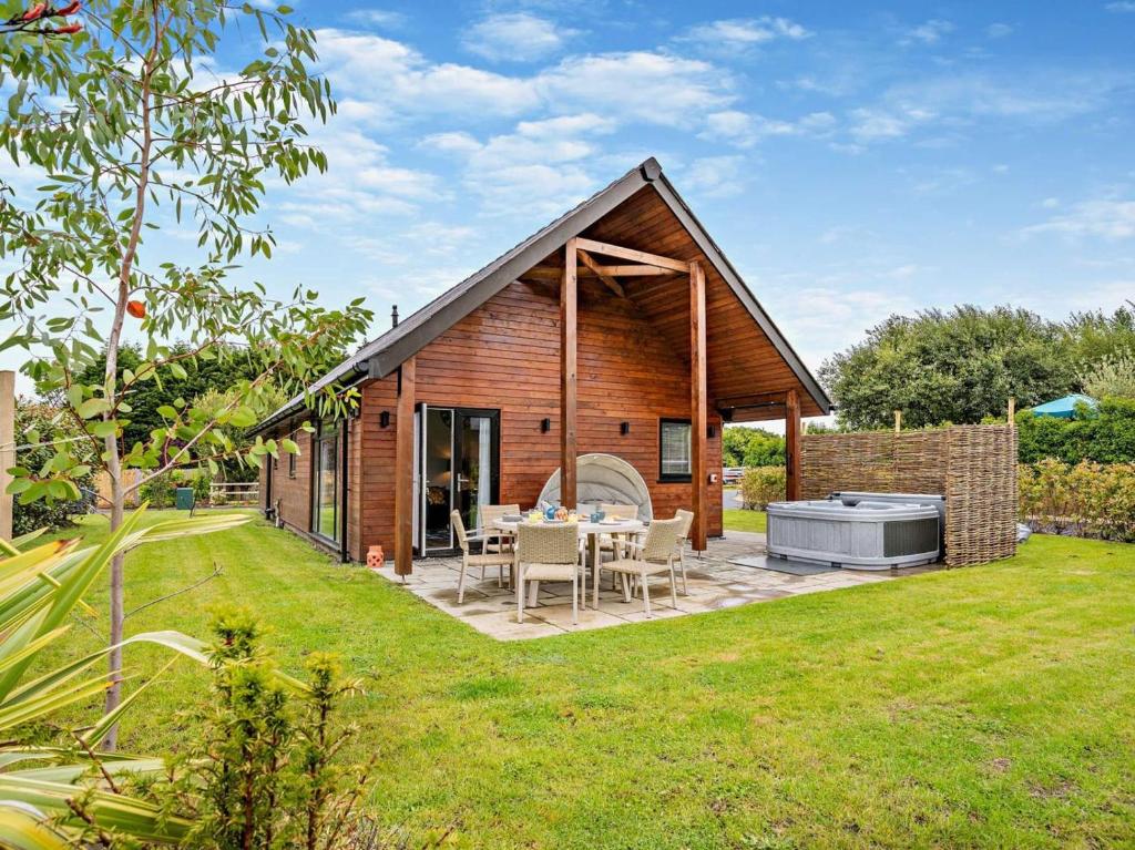 a small cabin with a table and a grill in a yard at 3 Bed in Swansea oc-91720 in Killay
