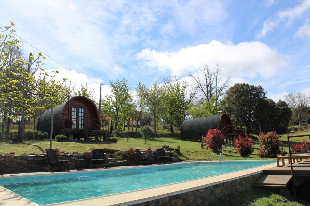 a resort with a swimming pool and a house at Quinta da Devesa -B2 in Vinhais