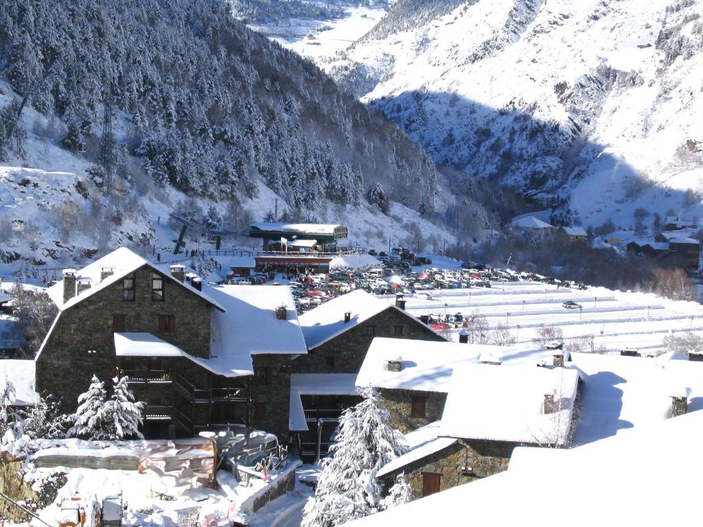 a village covered in snow with mountains in the background at AC Apartaments Sol Tarter in El Tarter