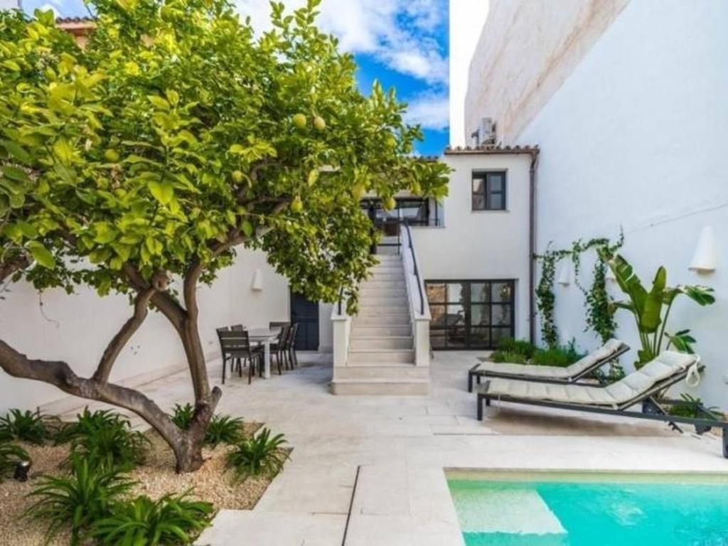 a villa with a swimming pool and a house at Can montis in Palma de Mallorca