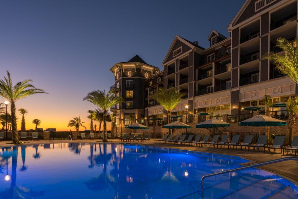 a view of a hotel with a pool at dusk at Henderson Beach Resort in Destin