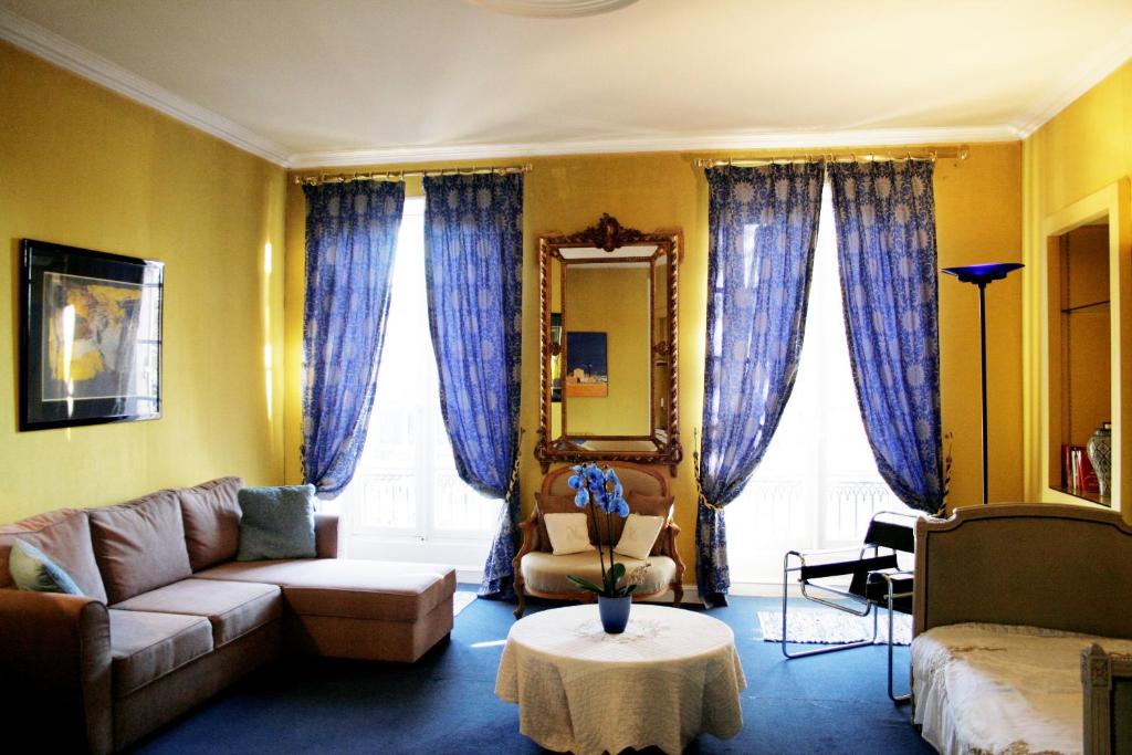 a living room with a couch and a table at chambres de charme "Florence" in Ribérac