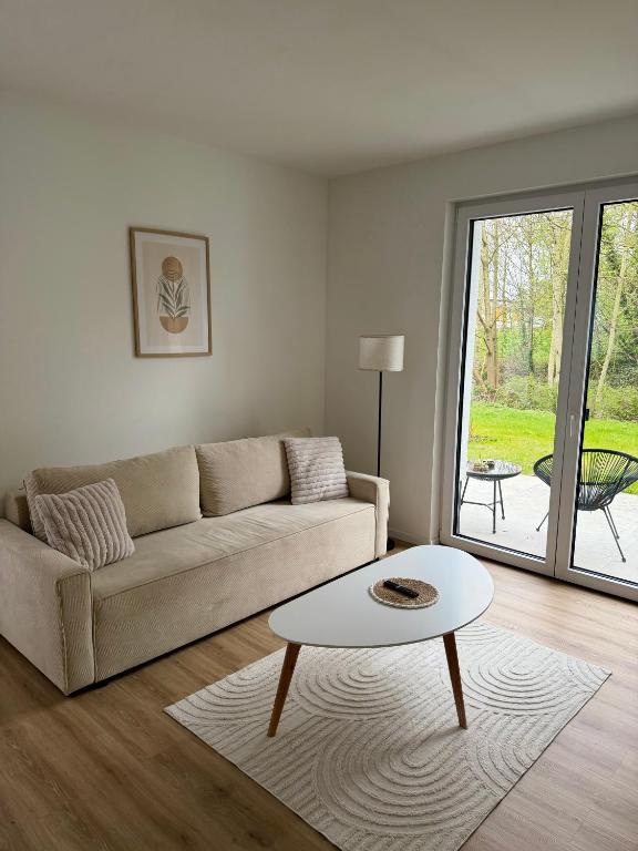 a living room with a couch and a table at Bauna Suites & Apartments in Baunatal