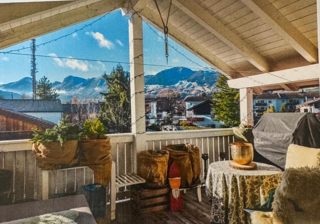 a balcony with a table and a view of the mountains at Das Alpenhostel in Brannenburg