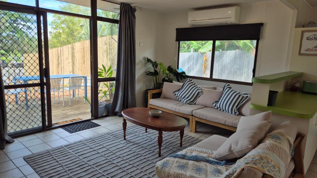 a living room with a couch and a table at Stay on Sooning in Nelly Bay
